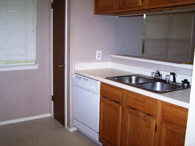 817 Lexington Rd, Elgin, TX 78621 - kitchen featuring baseboards, wallpapered walls, light countertops, dishwasher, and a sink