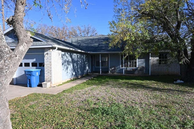 817 Lexington Rd, Elgin, TX 78621 - exterior space featuring a yard, an attached garage, concrete driveway, brick siding, and roof with shingles