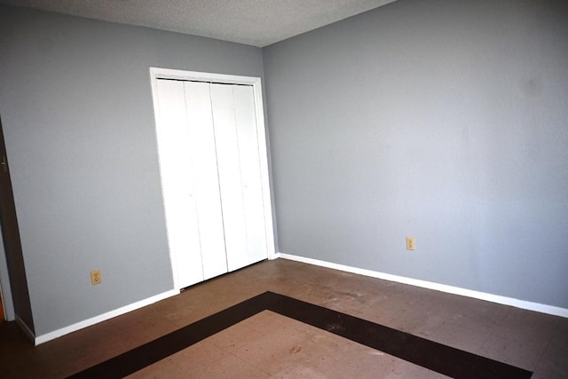 817 Lexington Rd, Elgin, TX 78621 - unfurnished bedroom featuring a closet, baseboards, and a textured ceiling