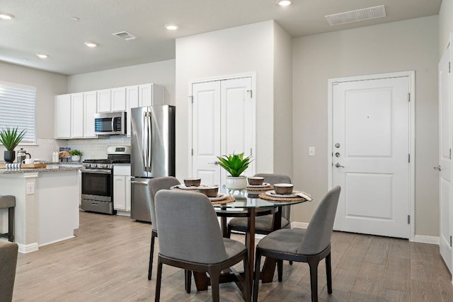 9015 Cattle Baron Path Unit 504, Austin, TX 78747 - dining space featuring light wood-style floors and recessed lighting