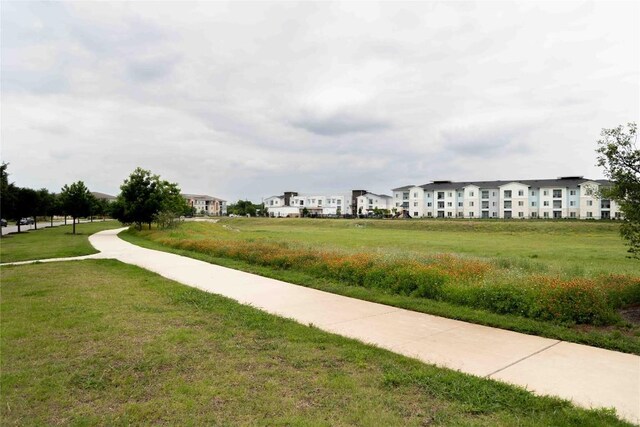 view of home's community with a yard