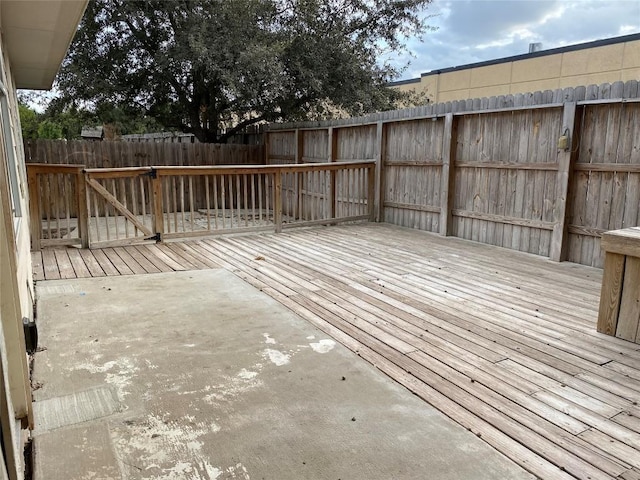 wooden terrace featuring fence