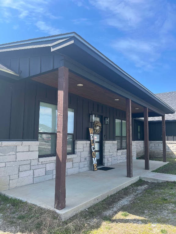 7143 Kc Ranch Ct, Temple, TX 76501 - view of exterior entry with board and batten siding and stone siding