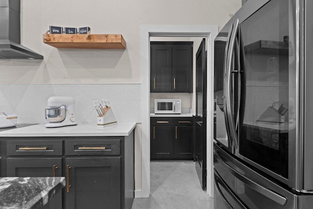 7143 Kc Ranch Ct, Temple, TX 76501 - kitchen featuring white microwave, wall chimney exhaust hood, tasteful backsplash, light countertops, and refrigerator with glass door