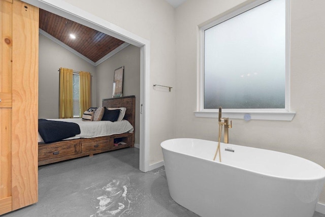 7143 Kc Ranch Ct, Temple, TX 76501 - ensuite bathroom featuring baseboards, a freestanding bath, crown molding, finished concrete floors, and lofted ceiling
