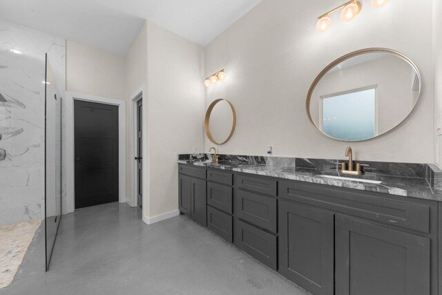 7143 Kc Ranch Ct, Temple, TX 76501 - full bathroom featuring baseboards, a sink, concrete flooring, double vanity, and a marble finish shower