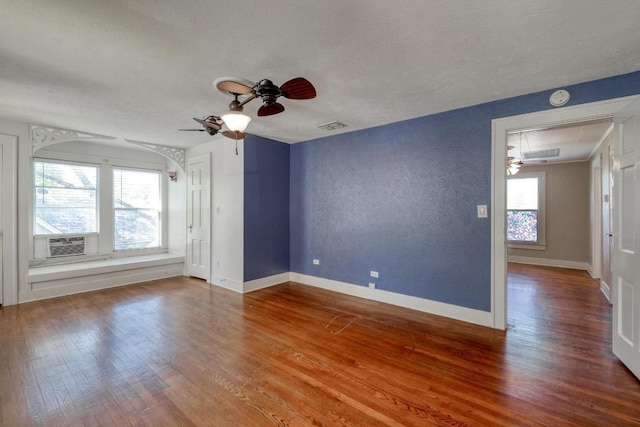 700 S Walnut Ave, Luling, TX 78648 - empty room with attic access, ceiling fan, wood finished floors, a textured ceiling, and a smoke detector