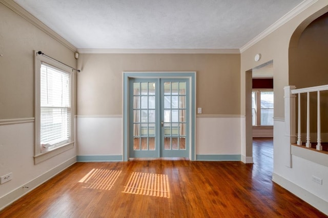 700 S Walnut Ave, Luling, TX 78648 - spare room featuring wood finished floors, arched walkways, and ornamental molding