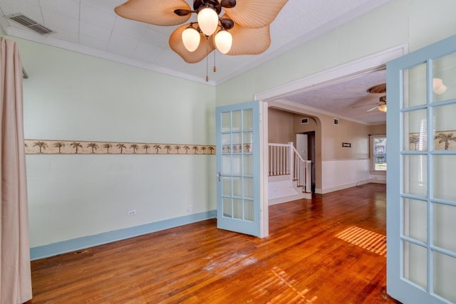 700 S Walnut Ave, Luling, TX 78648 - empty room featuring ceiling fan, crown molding, wood finished floors, and stairs