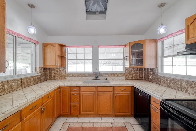 700 S Walnut Ave, Luling, TX 78648 - kitchen with black appliances, lofted ceiling, backsplash, glass insert cabinets, and pendant lighting