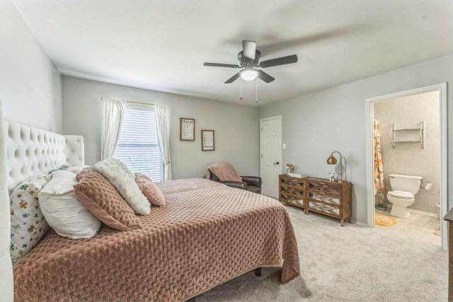 1515 Kothman Dr, Hutto, TX 78634 - bedroom with light carpet, a ceiling fan, ensuite bath, and baseboards