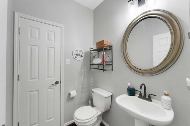 1515 Kothman Dr, Hutto, TX 78634 - bathroom with a sink, baseboards, and toilet