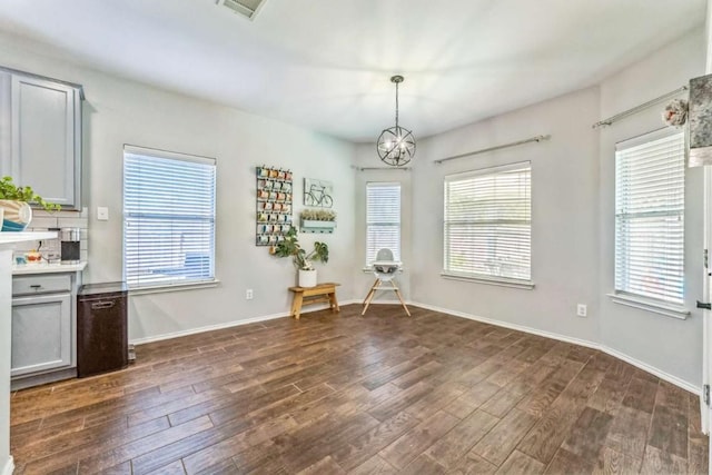 1515 Kothman Dr, Hutto, TX 78634 - dining area featuring dark wood-style flooring, plenty of natural light, and a chandelier