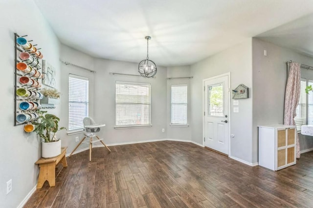 1515 Kothman Dr, Hutto, TX 78634 - foyer with dark wood-type flooring, a chandelier, and baseboards