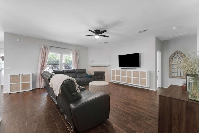 1515 Kothman Dr, Hutto, TX 78634 - living area with ceiling fan, a tile fireplace, and dark wood-type flooring
