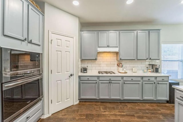 1515 Kothman Dr, Hutto, TX 78634 - kitchen featuring gray cabinetry, black microwave, oven, backsplash, and recessed lighting
