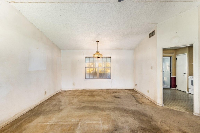 810 San Jacinto St, Lockhart, TX 78644 - carpeted spare room with a textured ceiling and a chandelier