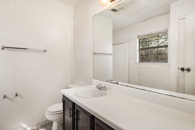 810 San Jacinto St, Lockhart, TX 78644 - bathroom featuring vanity and a textured ceiling