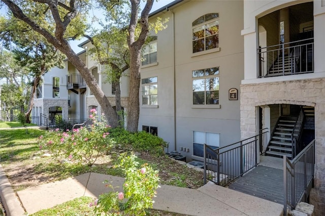 6000 Shepherd Mountain Cv Unit 407, Austin, TX 78730 - view of home's exterior featuring stucco siding and stone siding