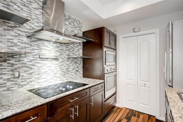 6000 Shepherd Mountain Cv Unit 407, Austin, TX 78730 - kitchen with wall chimney range hood, appliances with stainless steel finishes, open shelves, decorative backsplash, and dark wood-type flooring