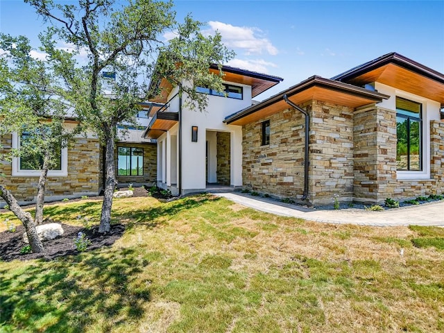 4800 Mondonedo Cv, Austin, TX 78738 - back of property with stone siding and a lawn