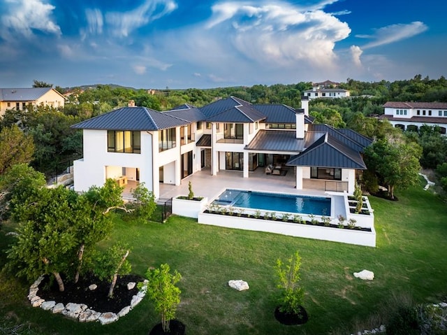 4800 Mondonedo Cv, Austin, TX 78738 - back of property featuring a balcony, a standing seam roof, and a metal roof