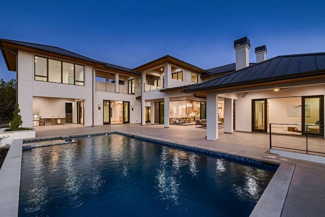 4800 Mondonedo Cv, Austin, TX 78738 - back of property featuring a standing seam roof, a metal roof, and stucco siding