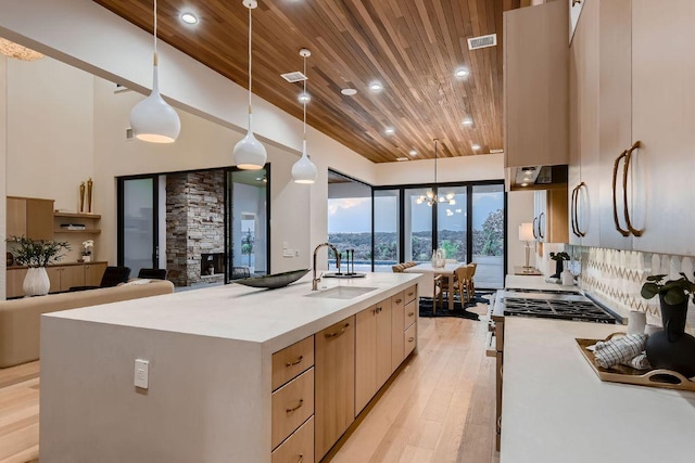 4800 Mondonedo Cv, Austin, TX 78738 - kitchen featuring wood ceiling, modern cabinets, light countertops, light brown cabinets, and hanging light fixtures