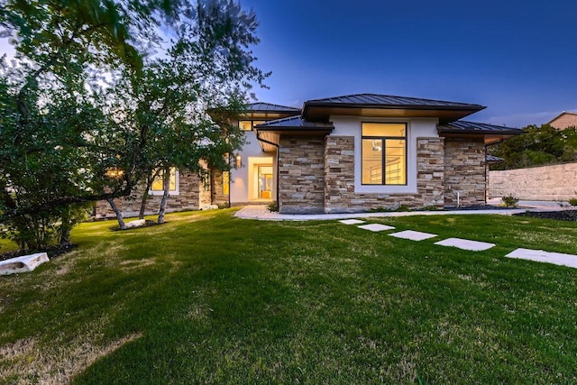 4800 Mondonedo Cv, Austin, TX 78738 - back of property with a standing seam roof, a metal roof, a yard, stone siding, and stucco siding