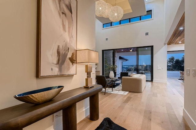 4800 Mondonedo Cv, Austin, TX 78738 - interior space featuring light wood finished floors, a chandelier, and a high ceiling
