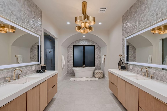 4800 Mondonedo Cv, Austin, TX 78738 - bathroom with tasteful backsplash, two vanities, a freestanding bath, a tile shower, and recessed lighting