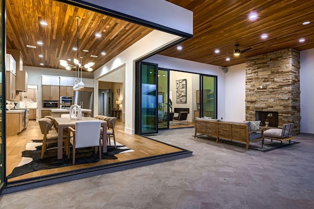 4800 Mondonedo Cv, Austin, TX 78738 - view of patio featuring exterior kitchen, outdoor dining area, ceiling fan, and an outdoor living space with a fireplace