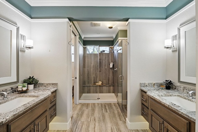 5200 Patagonia Pass, Austin, TX 78738 - bathroom featuring a stall shower, two vanities, baseboards, and ornamental molding