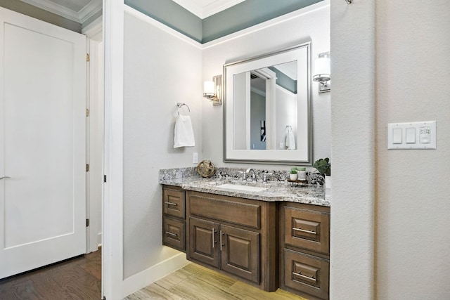 5200 Patagonia Pass, Austin, TX 78738 - bathroom featuring vanity, crown molding, wood finished floors, and baseboards