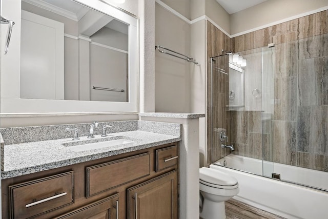 5200 Patagonia Pass, Austin, TX 78738 - bathroom featuring vanity, toilet, bath / shower combo with glass door, crown molding, and wood finished floors
