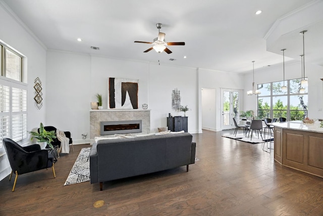 5200 Patagonia Pass, Austin, TX 78738 - living area with ceiling fan, a tiled fireplace, recessed lighting, a chandelier, and crown molding