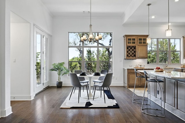 5200 Patagonia Pass, Austin, TX 78738 - dining area featuring crown molding, a chandelier, healthy amount of natural light, dark wood-type flooring, and recessed lighting