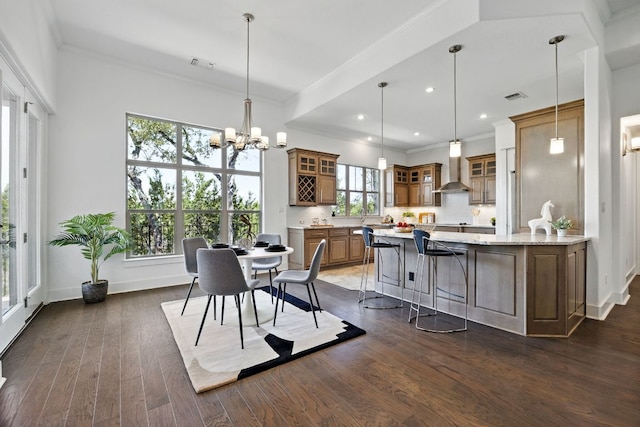 5200 Patagonia Pass, Austin, TX 78738 - dining space with dark wood-style flooring, crown molding, baseboards, a chandelier, and recessed lighting