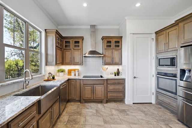5200 Patagonia Pass, Austin, TX 78738 - kitchen with appliances with stainless steel finishes, wall chimney range hood, a sink, tasteful backsplash, and plenty of natural light
