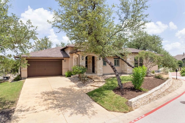5200 Patagonia Pass, Austin, TX 78738 - view of front facade featuring an attached garage, driveway, stone siding, stucco siding, and a tile roof