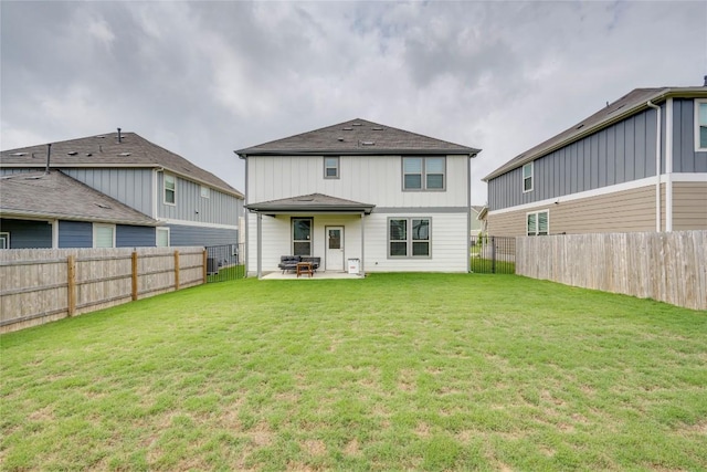 rear view of property with a patio, a lawn, and a fenced backyard