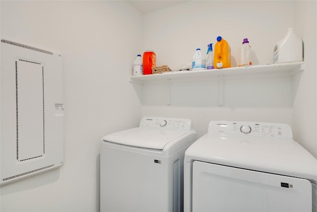 clothes washing area with washing machine and clothes dryer and laundry area