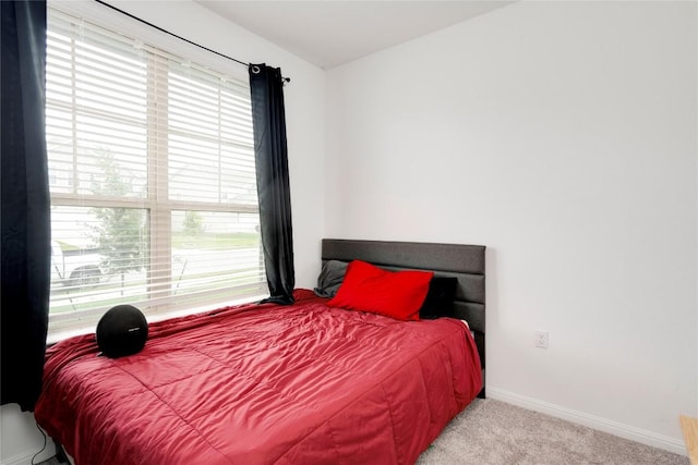 carpeted bedroom with baseboards