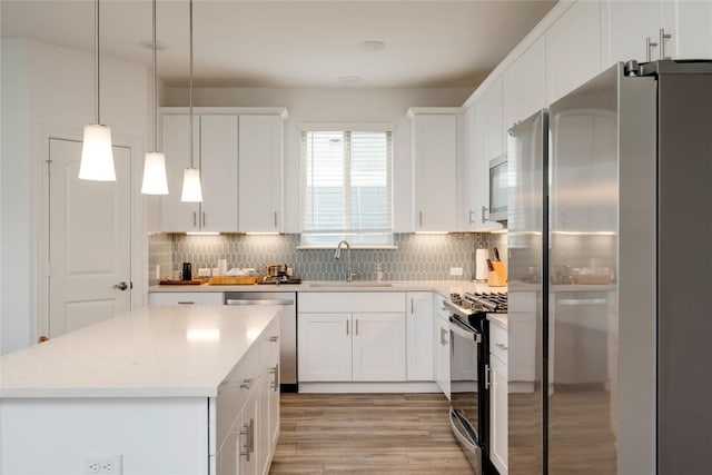 5408 Mars Ln, Austin, TX 78724 - kitchen featuring stainless steel appliances, backsplash, light countertops, and white cabinets