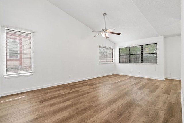 8902 Trone Cir Unit A, Austin, TX 78758 - empty room featuring plenty of natural light, a ceiling fan, light wood finished floors, and high vaulted ceiling
