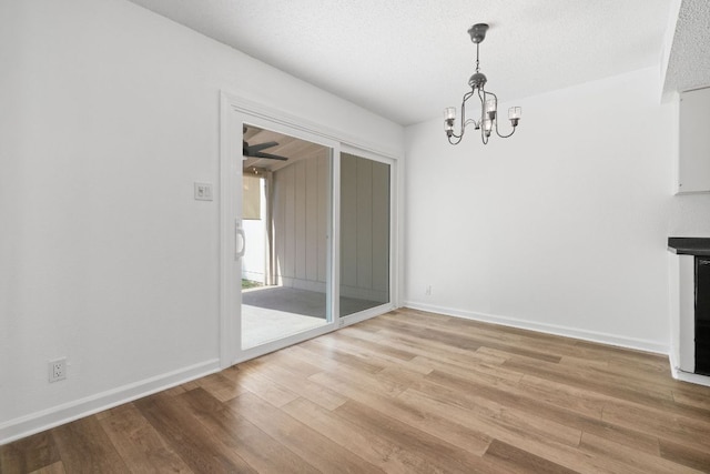 8902 Trone Cir Unit A, Austin, TX 78758 - unfurnished dining area with a chandelier and light wood-style floors