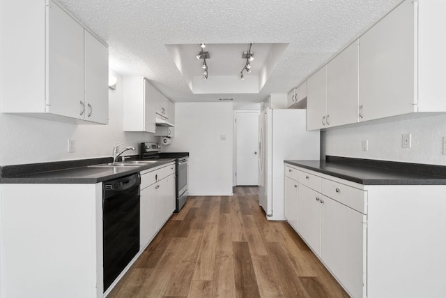 8902 Trone Cir Unit A, Austin, TX 78758 - kitchen with stainless steel range with electric cooktop, black dishwasher, a textured ceiling, dark countertops, and a tray ceiling
