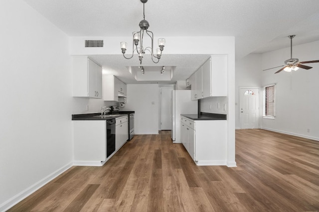 8902 Trone Cir Unit A, Austin, TX 78758 - kitchen with dark countertops, dishwasher, wood finished floors, stainless steel range with electric stovetop, and a chandelier