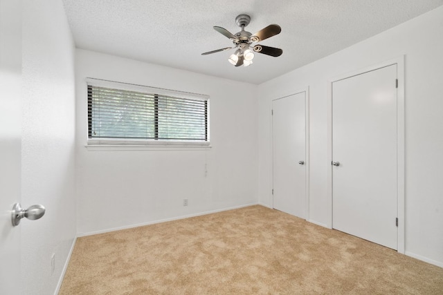 8902 Trone Cir Unit A, Austin, TX 78758 - unfurnished bedroom featuring carpet flooring, a textured ceiling, and a ceiling fan