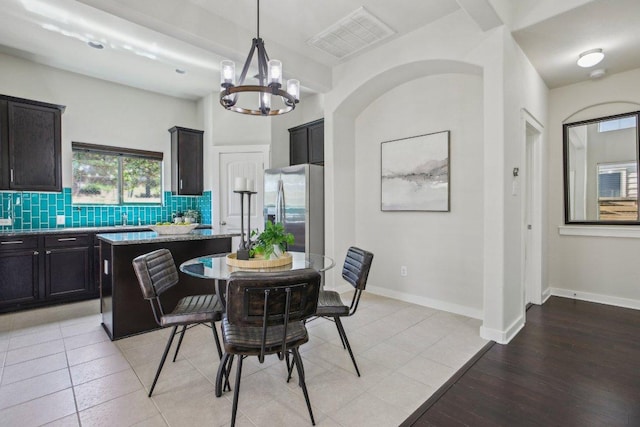 2001 Faro Dr Unit 29, Austin, TX 78741 - dining space featuring a notable chandelier, visible vents, baseboards, and light wood-style flooring